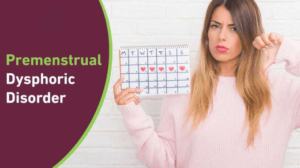 Woman holding a menstrual cycle calendar with text reading Premenstrual Dysphoric Disorder, expressing frustration.