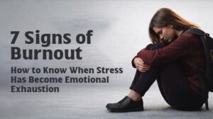 Woman sitting alone looking exhausted next to text “7 Signs of Burnout – How to Know When Stress Has Become Emotional Exhaustion.”