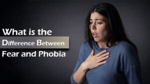 Woman looking anxious and holding her chest next to text about the difference between fear and phobia.