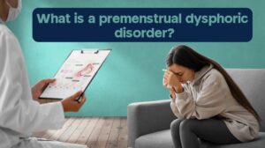 Woman discussing premenstrual dysphoric disorder (PMDD) symptoms with a doctor during a mental health consultation.