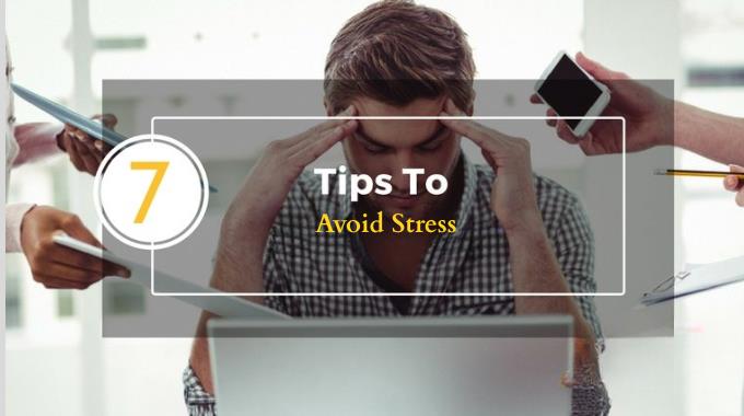 Man feeling stressed at work with laptop and distractions, representing tips to avoid stress.