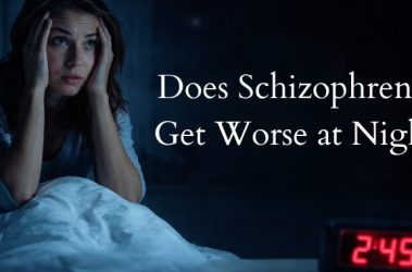 Woman awake at night with anxiety and insomnia, illustrating schizophrenia symptoms worsening at night.